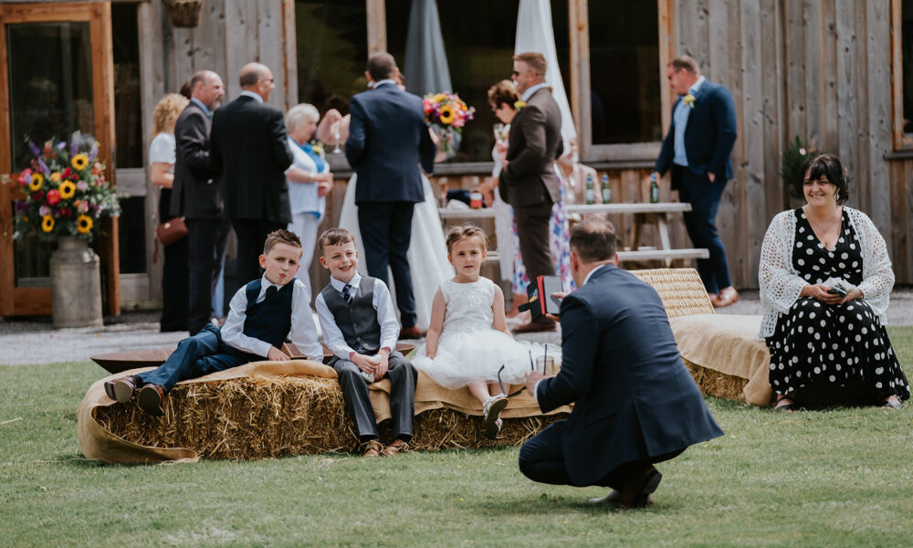 Straw bale seating outside wedding barn