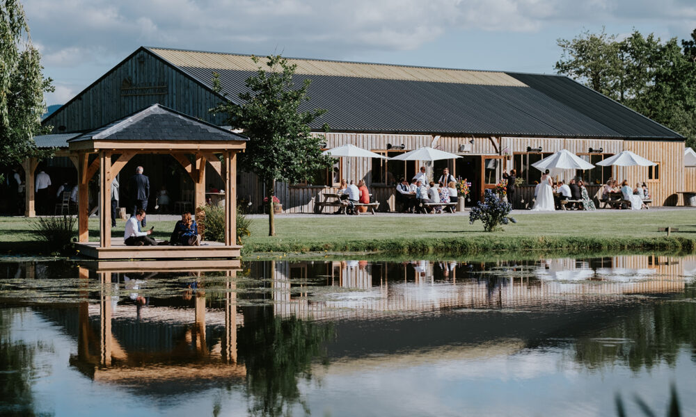 drinks on the lawn outside wedding barn