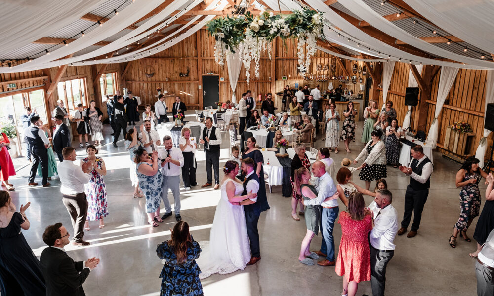 Wedding couple first dance inside the barn