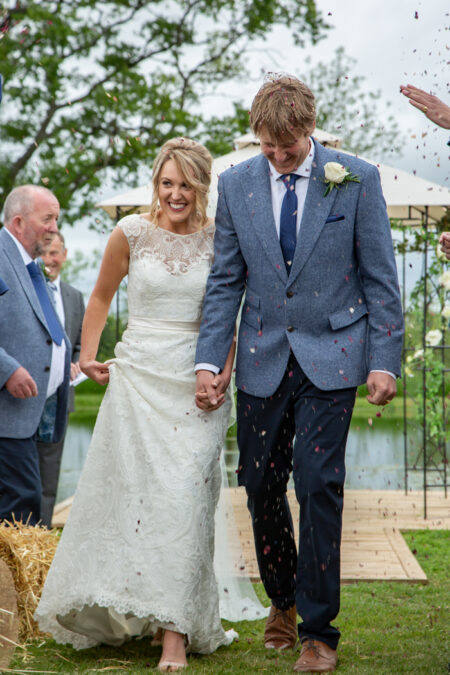 lakeside marraige ceremony, with newly weds smothered in confetti