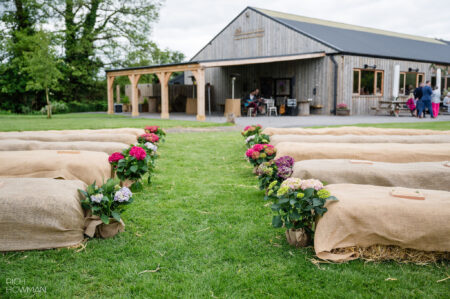 Outdoor ceremony lakeside with straw bales